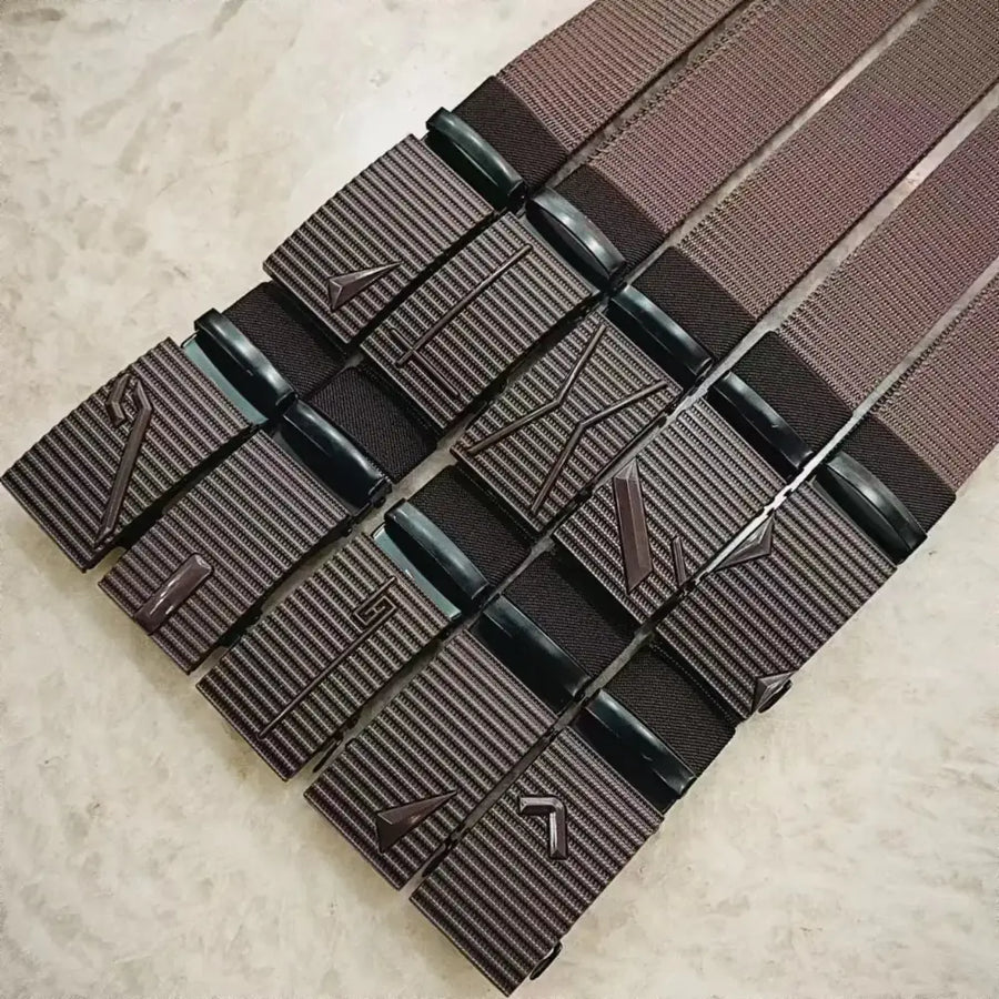 Brown woven belt with a textured, ribbed buckle featuring embossed geometric patterns and black plastic accents.