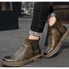 Olive green leather ankle boots with a ribbed knit cuff and zipper detail