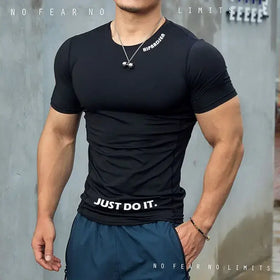 Black short-sleeved compression shirt with white ’just do it.’ text across the waistband and a small logo on the collar.