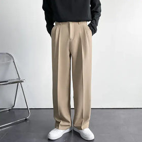 Beige pleated trousers with a smooth, tailored fabric and classic front pockets.