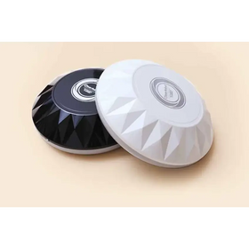 Two sleek, circular wireless chargers with a faceted diamond-like design—one in glossy black and one in matte white—each featuring a central branded logo.