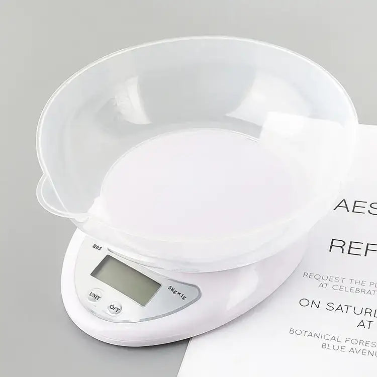 White digital kitchen scale with transparent bowl on top