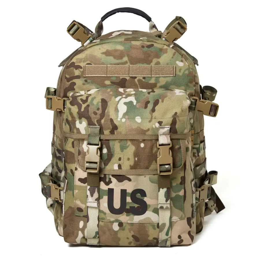 Multicam-patterned tactical backpack with tan and olive green camouflage, featuring a prominent ’us’ patch on the front.