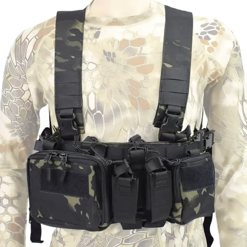 Black and green camouflage tactical chest rig with multiple zippered compartments and adjustable straps.