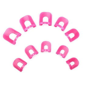 Bright pink plastic nail guards arranged in a circular pattern.