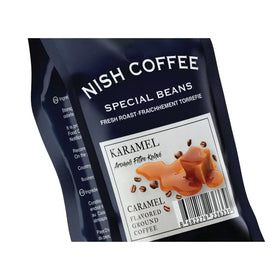 Dark blue pouch of nish coffee special beans, caramel flavored ground coffee with a white label featuring an illustration of caramel and coffee beans.