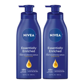 Two identical dark blue nivea essentially enriched body lotions with pump dispensers, each labeled as containing 500 ml of deep nourishing serum and almond oil.