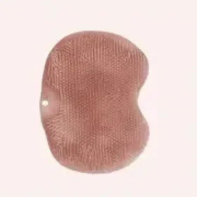A soft, rose-gold colored bath sponge with a textured surface and rounded edges.