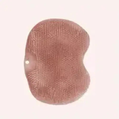 A soft, rose-gold colored bath sponge with a textured surface and rounded edges.