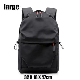 Black nylon backpack with red zipper pulls and side drawstrings.