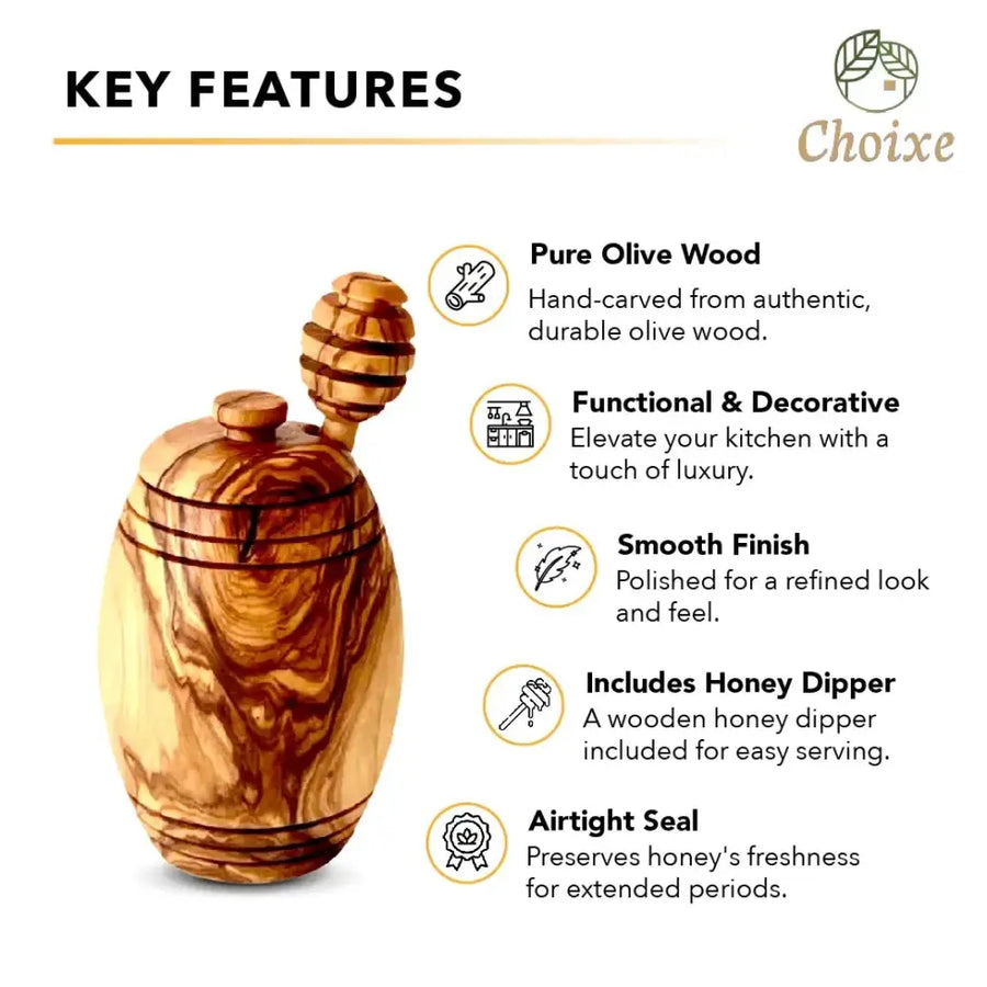 Hand-carved olive wood honey jar with a natural, polished finish and an attached wooden dipper.