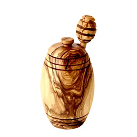 Handcrafted olive wood honey jar with a natural, swirling grain pattern and a matching wooden dipper.