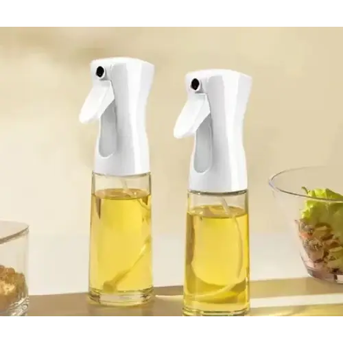 Two white spray bottles with clear glass bodies filled with golden-yellow liquid.