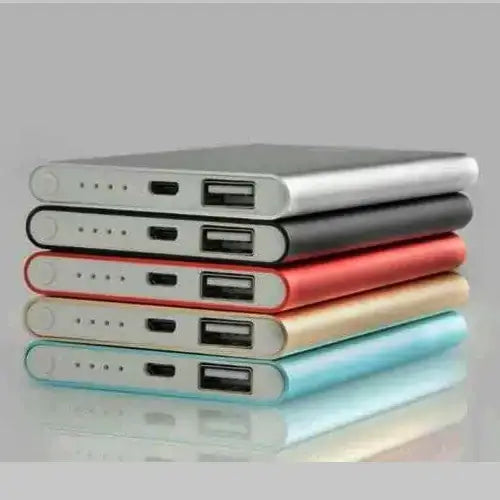 Stacked rectangular power banks in silver, black, red, gold, and light blue with usb ports on the side.