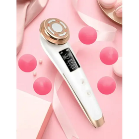 White and gold facial care device with a sleek, ergonomic design featuring a circular treatment head and digital display.