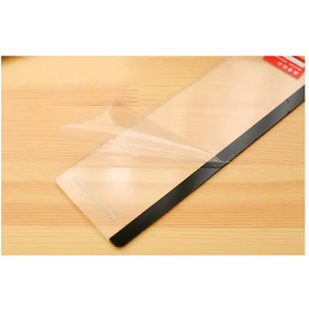Clear protective screen film with a black border, partially peeled back to reveal its adhesive side.