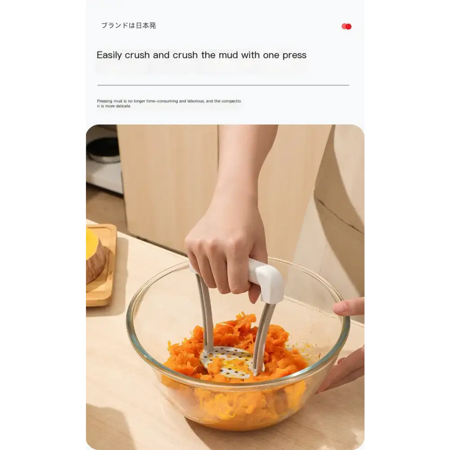 White-handled potato masher with metallic pressing arms and perforated base, shown crushing orange sweet potatoes in a clear glass bowl.