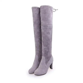 Gray suede over-the-knee boots with a block heel and adjustable strap at the back.