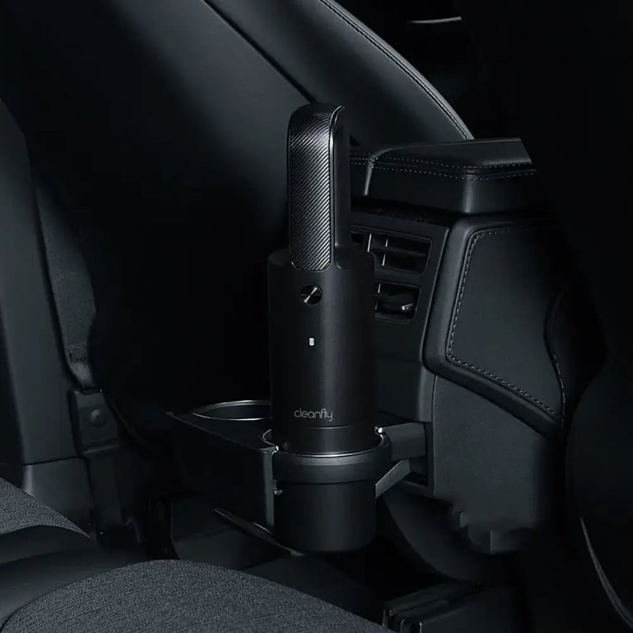 Black carbon-fiber-textured handheld car vacuum with ’cleanfly’ branding