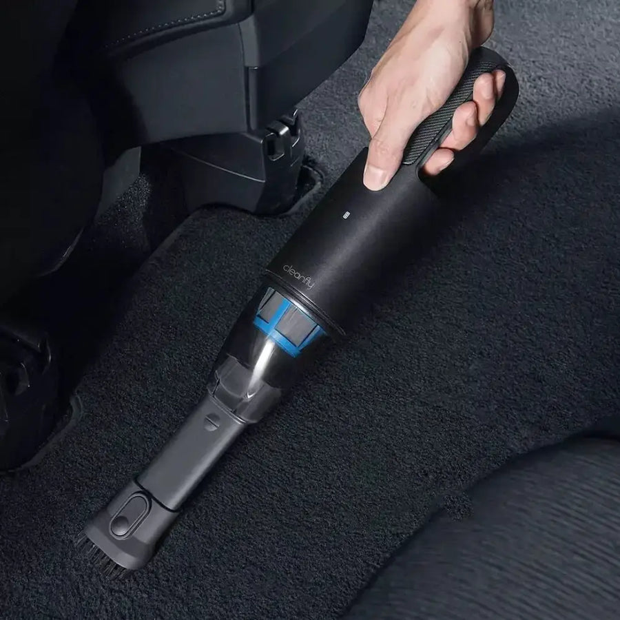 Black handheld car vacuum cleaner with a transparent dust collection chamber and blue internal components, featuring the ’cleanly’ brand logo on its body.