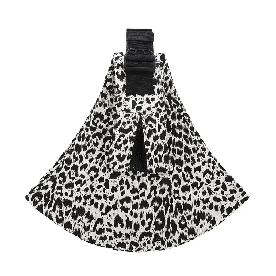 Black and white leopard-print fabric pet carrier with a black adjustable strap.
