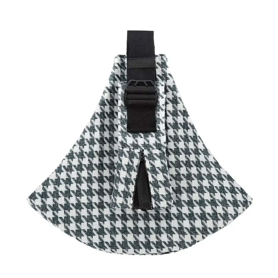 Black and white houndstooth patterned fabric pet carrier with adjustable black strap.