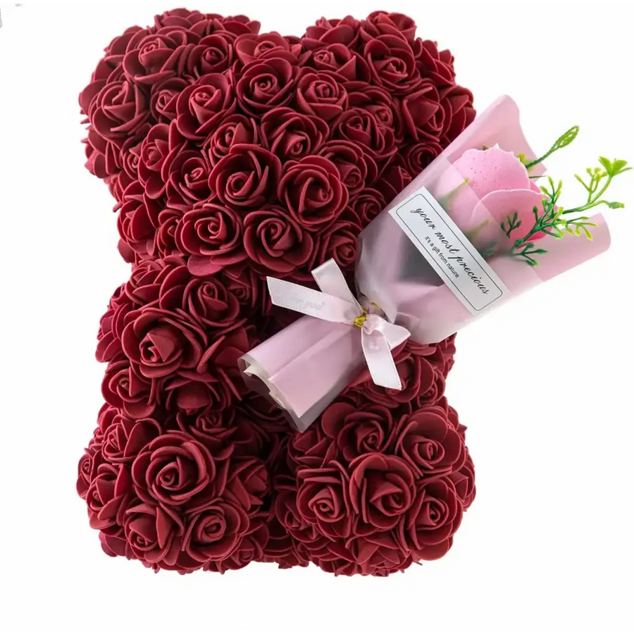 A plush teddy bear crafted entirely from dense, deep red foam roses.