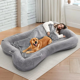 Gray plush rectangular dog bed with soft cushioned edges and a matching blanket