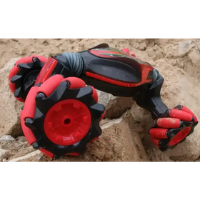 Red and black robotic arm toy car with articulated joints and chunky, textured wheels.