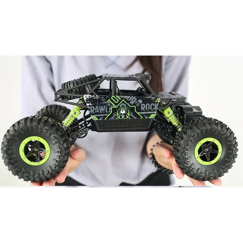 Black and neon green remote-controlled rock crawler with rugged off-road tires, a skeletal logo design on the side panel, and visible suspension components.