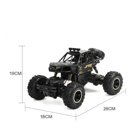 Black remote-controlled off-road truck with gold lettering and detailing, featuring oversized rugged tires and a spare tire mounted on the back.