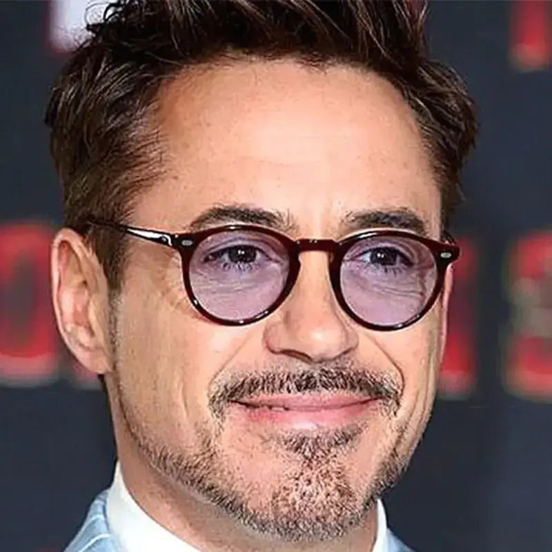 A pair of dark tortoiseshell-framed round glasses with a sleek, modern design.