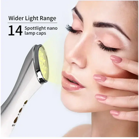 Silver and white handheld facial device with 14 spotlight nano lamp caps emitting a soft yellow glow.