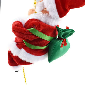 Red and white plush santa claus figurine with a green ribbon-tied sack.