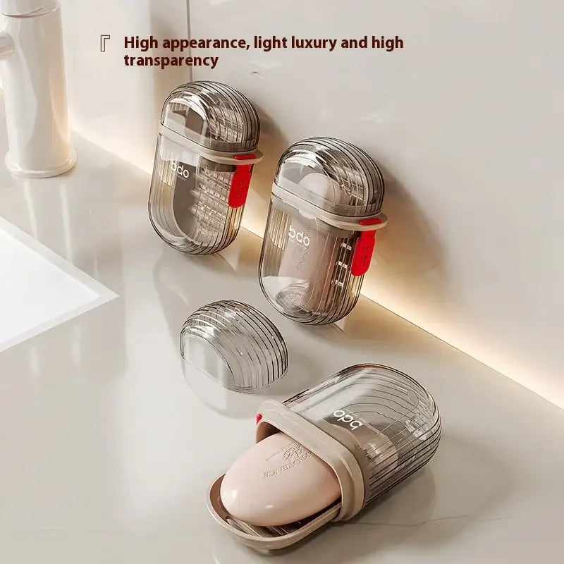 Transparent, ribbed plastic soap dish with a beige silicone insert and red accent clip.