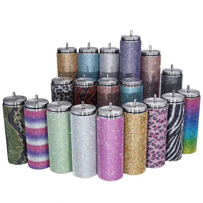 A collection of sparkling, rhinestone-encrusted insulated tumblers in various vibrant colors and patterns.