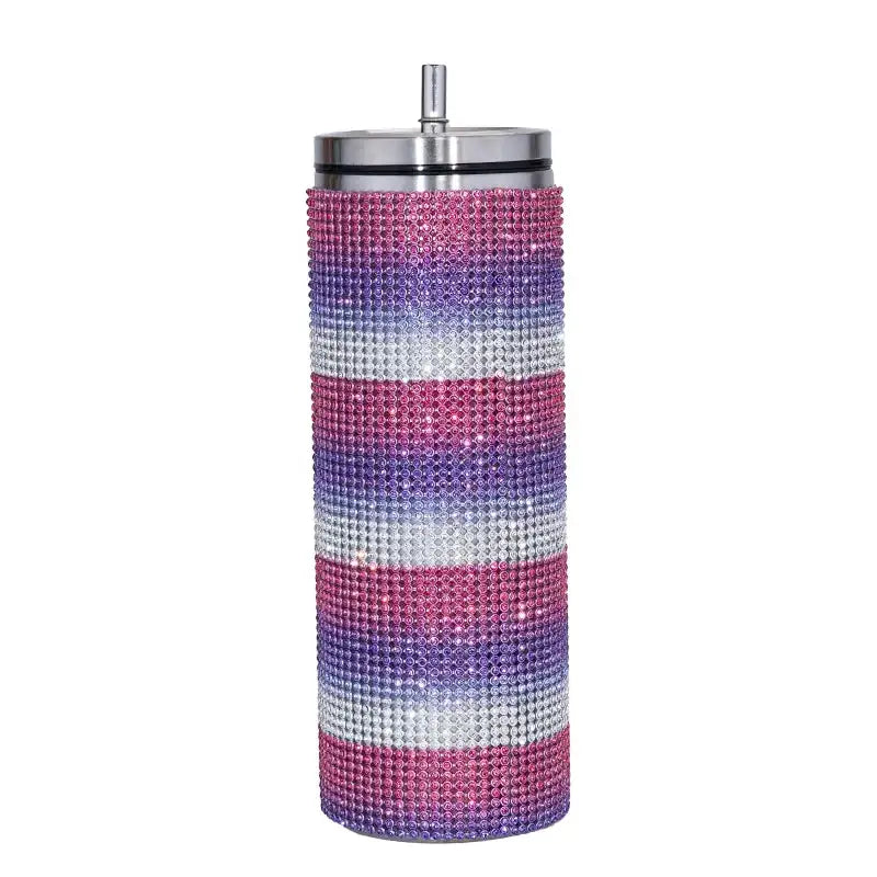 A tall, cylindrical insulated tumbler adorned with horizontal stripes of pink, purple, and silver rhinestones, featuring a sleek stainless steel lid and straw.