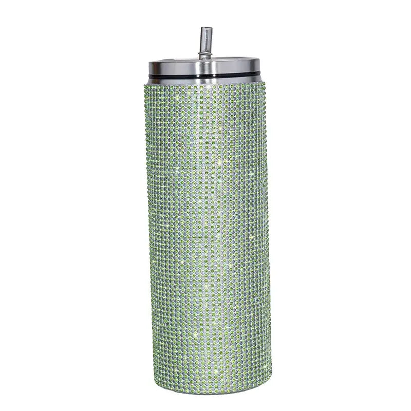 A tall, slender green rhinestone-encrusted insulated tumbler with a silver lid and straw.
