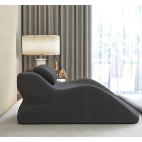 Black ergonomic recliner with smooth, contoured design and plush fabric upholstery.