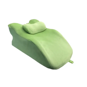 A soft, light green plush reclining lounge chair with a matching pillow.