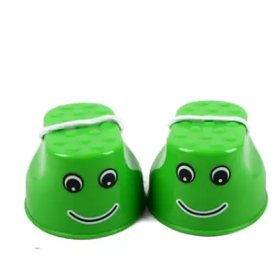 Green plastic cups with smiling faces and black eyes, tied together by a white rubber band.