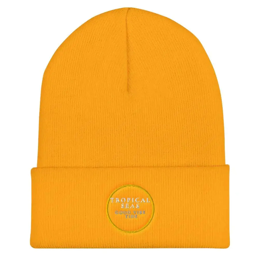 A vibrant yellow ribbed knit beanie with a folded cuff and embroidered circular logo reading ’tropical seas good tide’.