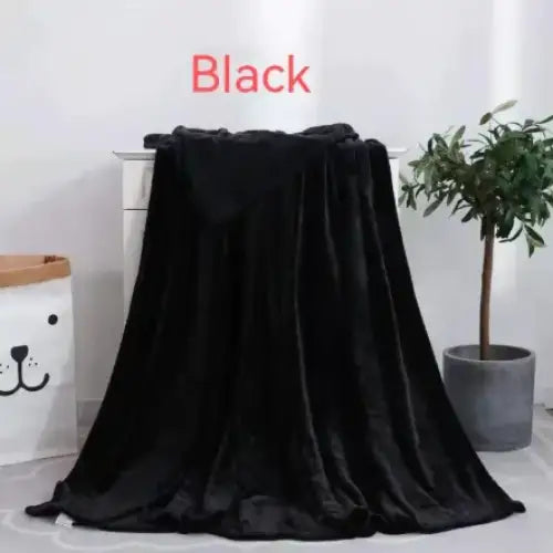 Black plush throw blanket with a soft, velvety texture.