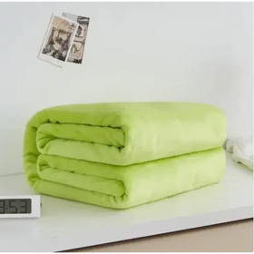 A soft, lime-green quilted blanket with a plush texture and neatly folded edges.