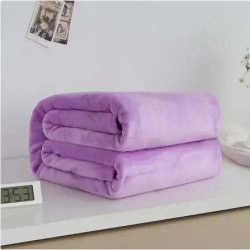 A soft, plush lavender throw blanket neatly folded into a compact stack.