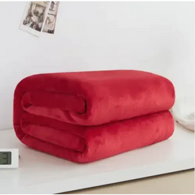 A plush, vibrant red throw blanket with a soft, velvety texture.