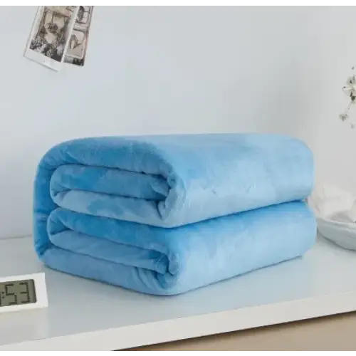 A soft, light blue plush blanket neatly folded into two layers on a white surface.