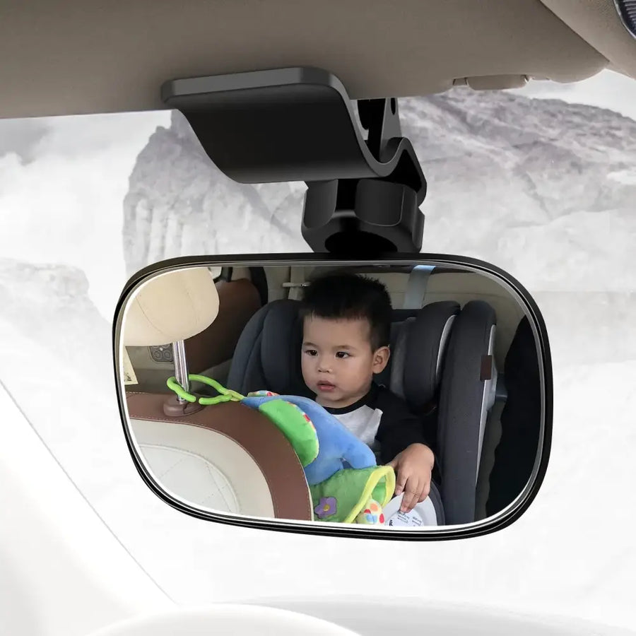 Black plastic car rearview mirror mount with a rectangular, rounded-edge reflective surface.