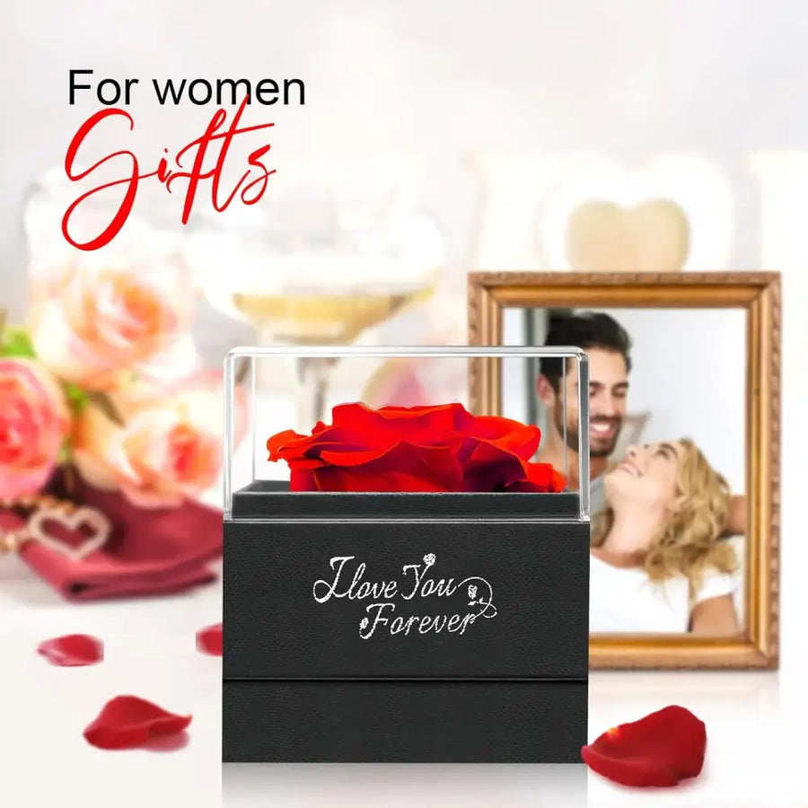 A vibrant red preserved rose elegantly displayed in a clear acrylic box atop a black textured base engraved with ’i love you forever.’