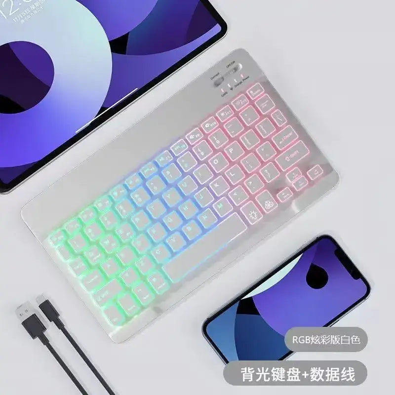 A sleek white wireless keyboard with vibrant rgb backlighting that transitions from green to pink across the keys.